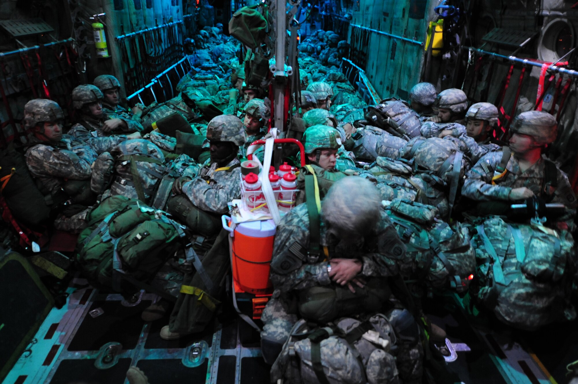 First Brigade paratroopers wait to parachute out of a C-130H during a Joint Operational Access Exercise Feb. 14, 2011 at Pope Air Force Base, N.C.  Solders jump out of troop doors at 800 feet simultaneously releasing their chutes immediately after exiting the aircraft.  (Photo by U.S. Air Force Senior Airman Jim Araos)