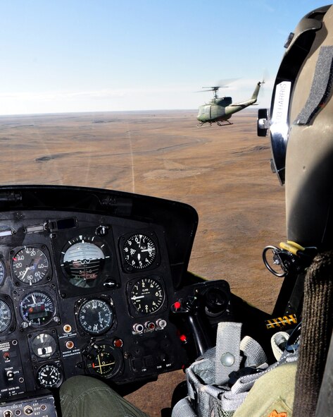 Maj. Dona Harris, 37th Helicopter Squadron, positions her UH-1N Huey helicopter in formation with the helicopter piloted by Capt. Matt Konowiez, 37th HS, Feb. 22. (U.S. Air Force photo by Airman 1st Class Dan Gage)
