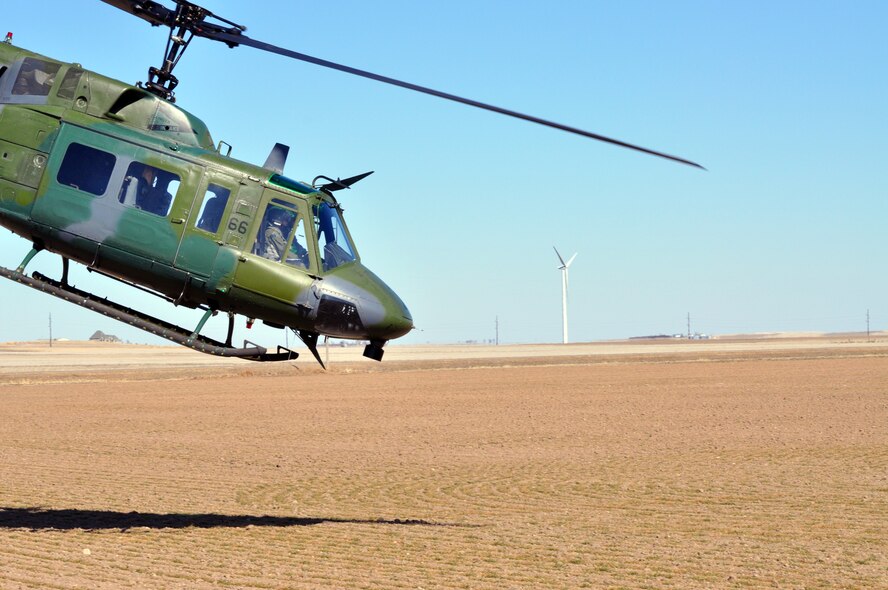 Maj. Dona Harris, 1st Lt. Eric Riethman and Staff Sgt. Joe Kendall, all from 37th Helicopter Squadron, depart Juliet-01 after dropping off their passengers for a visit to the MAF Feb. 22. (U.S. Air Force photo by Airman 1st Class Dan Gage)