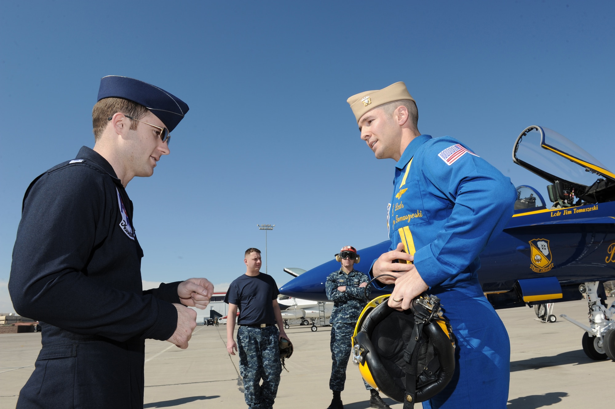 Capt. Ryan Riley (left) greets Lt. Cmdr. Jim Tomaszeski Feb. 23, 2011, at Nellis Air Force Base, Nev. Captain Riley is the Thunderbirds left wing. Commander Tomaszeski is the Navy Blue Angels right wing. (U.S. Air Force photo/Staff Sgt. Larry E. Reid Jr.)