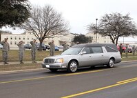 Men and women from Lackland line the street Feb. 24 as a show of respect for Airman 1st Class Corey C. Owens, an Airman from San Antonio who died Feb. 17 during a deployment to Al Asad Air Base, Iraq. Airman Owens was assigned to the 47th Security Forces Squadron, Laughlin Air Force Base, Texas. (U.S. Air Force photo/Tony Morano)