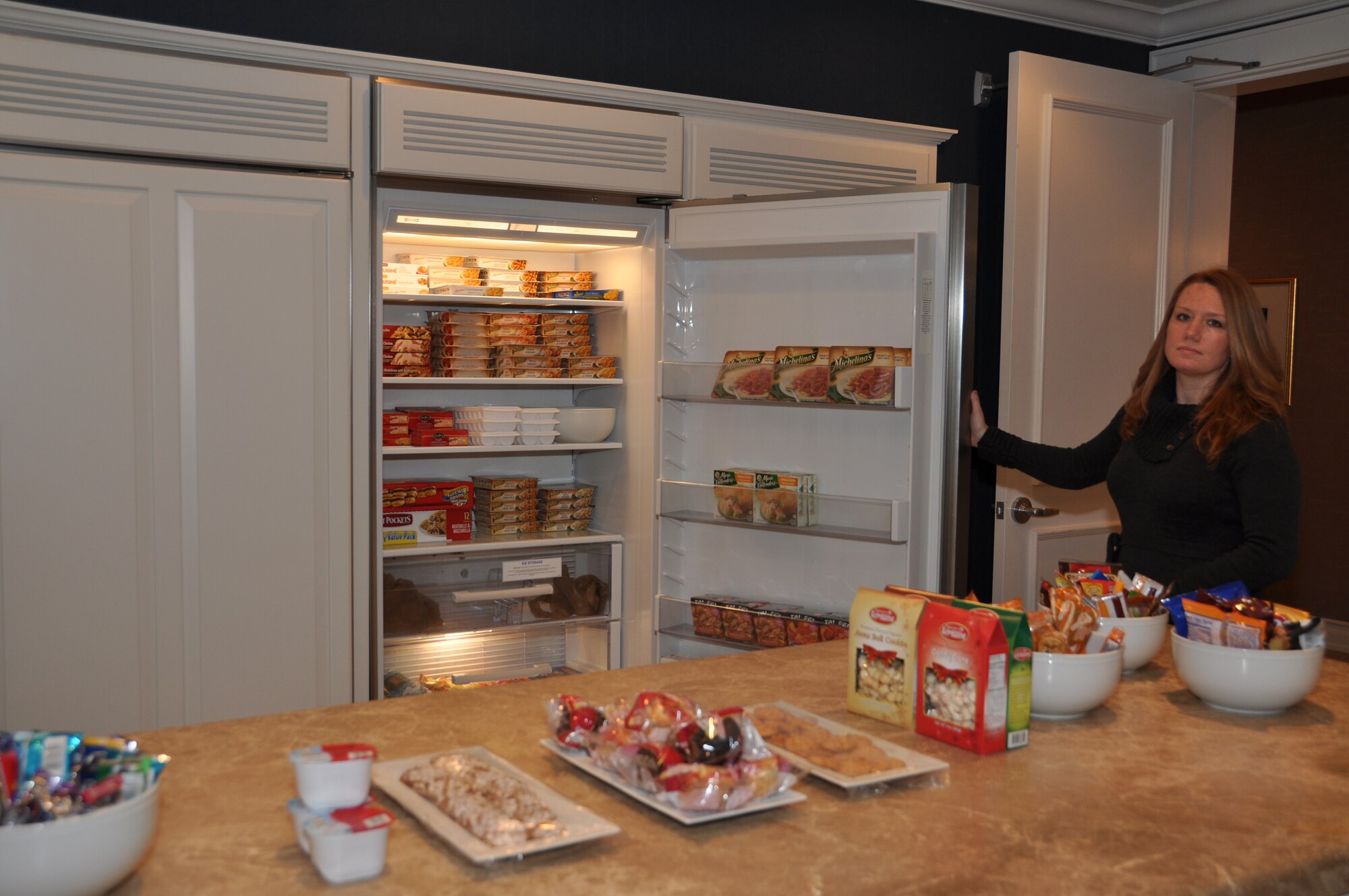 Wendy Fish, USO Families of the Fallen Support Manager, shows a sampling
of what is provided in the kitchen for families when they come to the Fisher
House for Families of the Fallen. (U.S. Air Force photo/Christin Michaud)