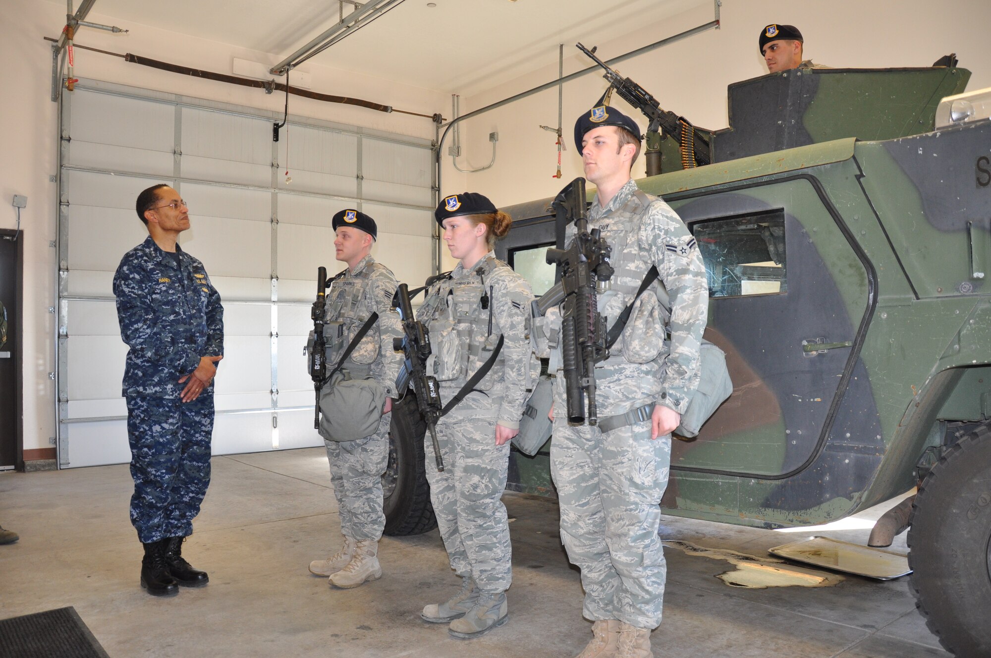 Vice Admiral Cecil Haney, U.S. Strategic Command deputy commander, receives a security forces post-brief from Senior Airman Jared Sparks, Airmen 1st Class Sara Wimberly and Adam Guy, and Airman Yaxcel Interian, all from 790th Missile Security Forces Squadron, during a visit to Warren’s Missile Alert Facility Juliet-01 Feb. 22. (U.S. Air Force photo by Airman 1st Class Dan Gage)