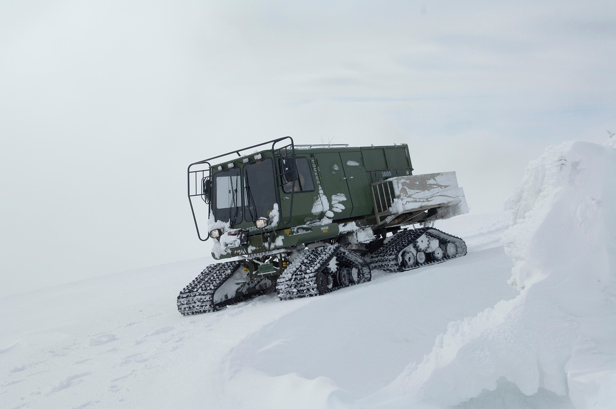 Transmission systems radio Airmen with the 92nd Communications Squadron and their guide from 336th Training Group get stuck in their enclosed all-terrain vehicle on their way up to a radio tower on the Calispell Mountain Peak in Cusick, Wash., Feb. 16, 2011. The vehicle got stuck a quarter mile away from the tower, which they have to de-ice throughout the year to maintain radio communications for the 336th Training Group at Fairchild Air Force Base, Wash., and local law enforcement. The Airmen made their way up to the tower by shoveling snow off the path. (U.S. Air Force photo/Senior Airman Natasha E. Stannard) 