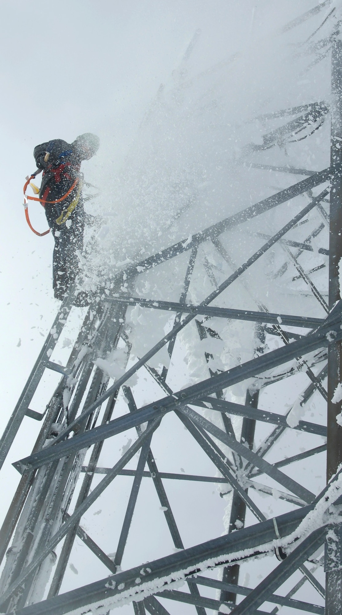 Airman 1st Class Miklos Jeszensky knocks snow and ice off a radio tower Feb. 16, 2011, on the Calispell Mountain Peak in Cusick, Wash. Airman Jeszensky is a transmission systems radio technician with the 92nd Communications Squadron at Fairchild Air Force Base, Wash., and is knocking ice of the tower to clear radio signals for the 336th Training Group and local law enforcement. Clearing this enables the 336th TRG to continue training for Survival, Evasion, and Resistance and Escape School students and accomplish rescues. (U.S. Air Force photo/Senior Airman Natasha E. Stannard)