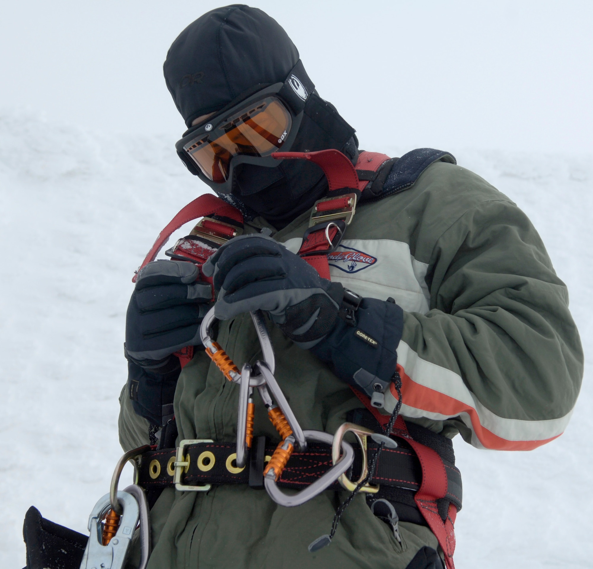 Airman 1st Class Shawn Westbrook fastens on his safety harness before climbing a radio tower Feb. 16, 2011, on the Calispell Mountain Peak in Cusick, Wash. Airman Westbrook is a transmission systems radio technician with the 92nd Communications Squadron at Fairchild Air Force Base, Wash., and is climbing the tower to knock snow and ice off of it. Doing this provides better radio communication for the 336th Training Group and local law enforcement. (U.S. Air Force photo/Senior Airman Natasha E. Stannard) 
