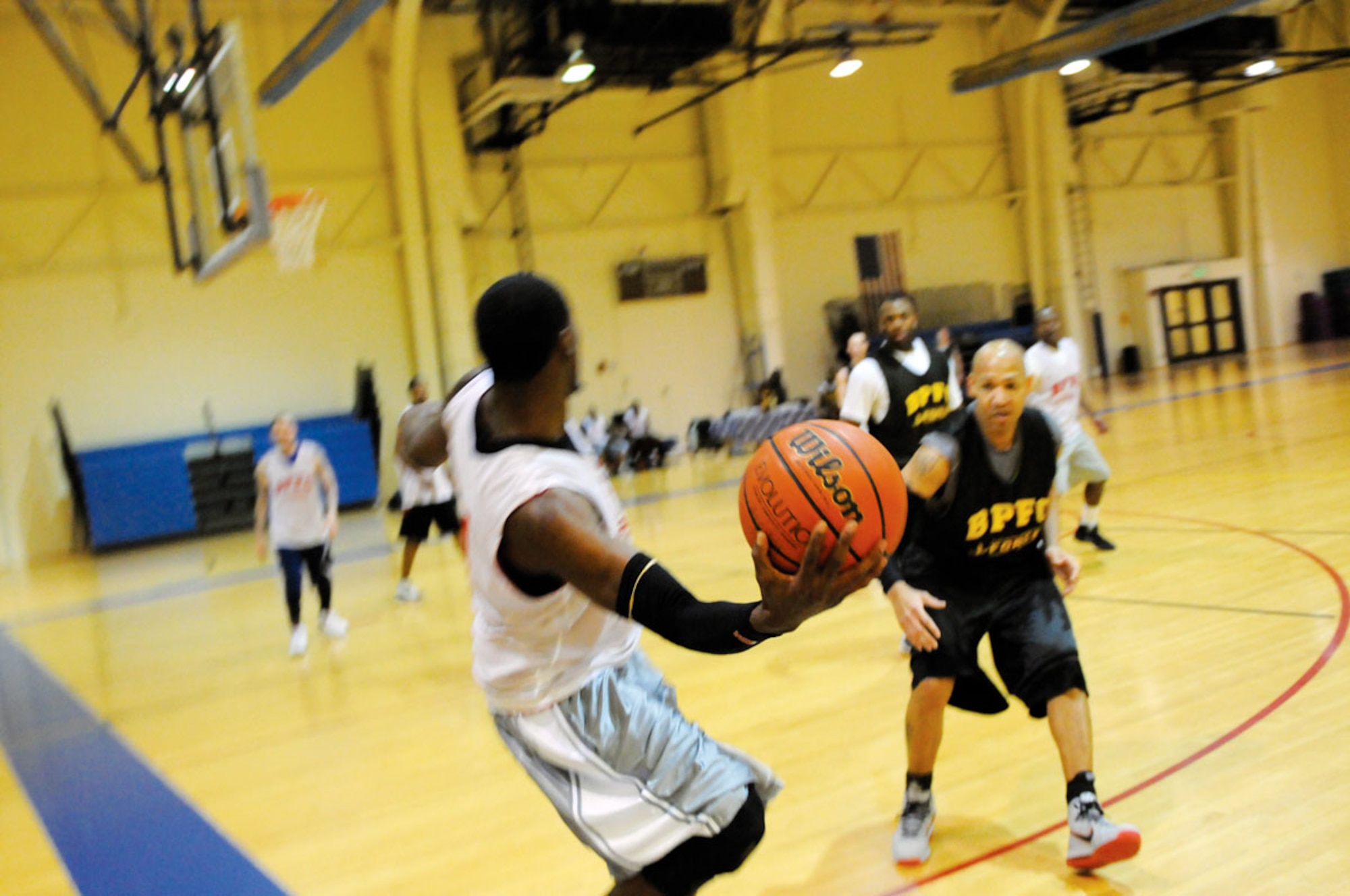 An Alaska National Guard, player passes the ball to his teammates. The National Guard played against A Company, 725th Brigade Support Battalion in the final game of intramural basketball season at Joint Base Elmendorf-Richardson. (U.S. Air Force photo/Steve White)