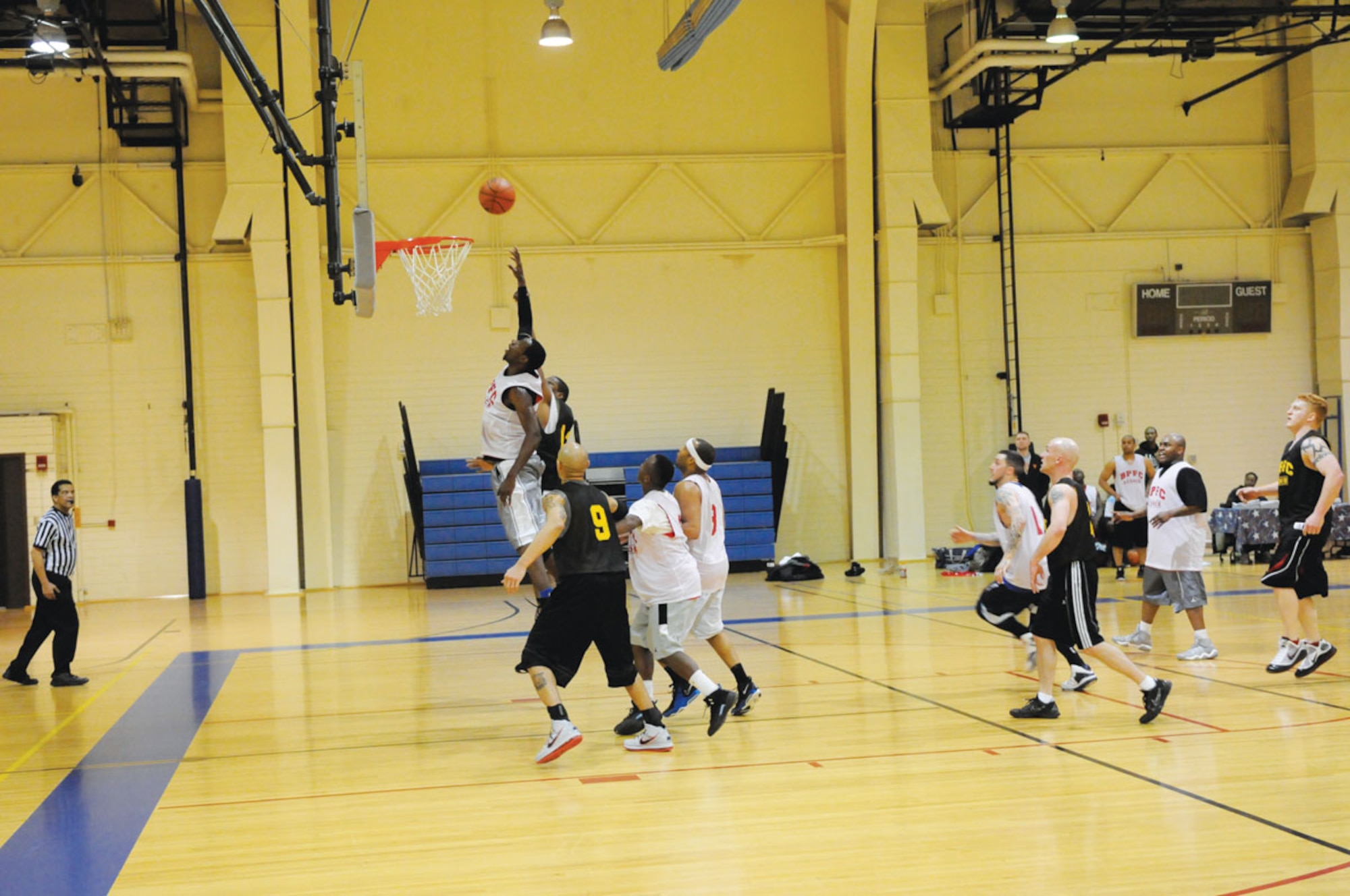 Alaska National Guard, in the white jerseys, player John Gory makes the final basket of the game played agains A Company, 725th Brigade Support Battalion. The game was the final of the intramural basketball season at Joint Base Elmendorf-Richardson. (U.S. Air Force photo/Steve White)