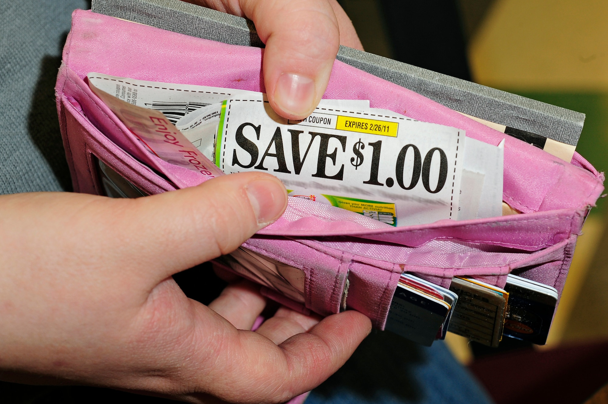 Whitney Burgett, Ellsworth Coupon Cutter page administrator, opens her wallet to show coupons she intends to use while shopping at Ellsworth Air Force Base, S.D., Feb. 22, 2011.  Coupons save families a large percentage of their costs for food and items used every day. (U.S. Air Force photo/Staff Sgt. Marc I. Lane)