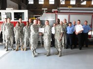 LAUGHLIN AIR FORCE BASE, Texas – Staff Sgt. Curtis Billig, 47th Civil Engineering Squadron, poses with Col. Michael Frankel, 47th Flying Training Wing commander, Chief Master Sgt. Michael King, 47th Mission Support Group superintendent, and fellow members of his squadron after being presented the XLer of the Week award Feb. 23. The XLer is a weekly award chosen by wing leadership and given to those who consistently make outstanding contributions to Laughlin and their unit. (U.S. Air Force photo by Airman 1st Class Blake Mize) 