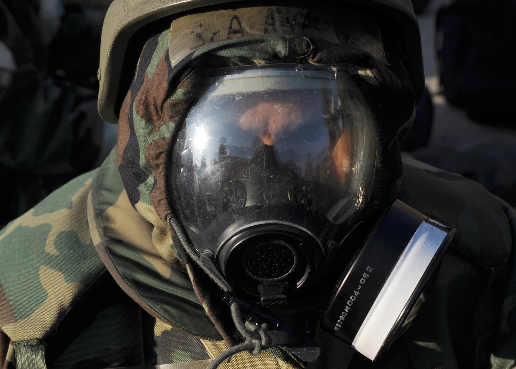Senior Airman Alvaro Cermeno, 22nd Communications Squadron transmissions systems technician, waits outside in a simulated bunker during an operational readiness exercise “chemical attack,” Feb. 15, 2011, McConnell Air Force Base, Kan. The exercise allows Airmen to practice executing their primary duties in hostile and chemically contaminated environments. (U.S. Air Force photo/Staff Sgt. Dallas Edwards)