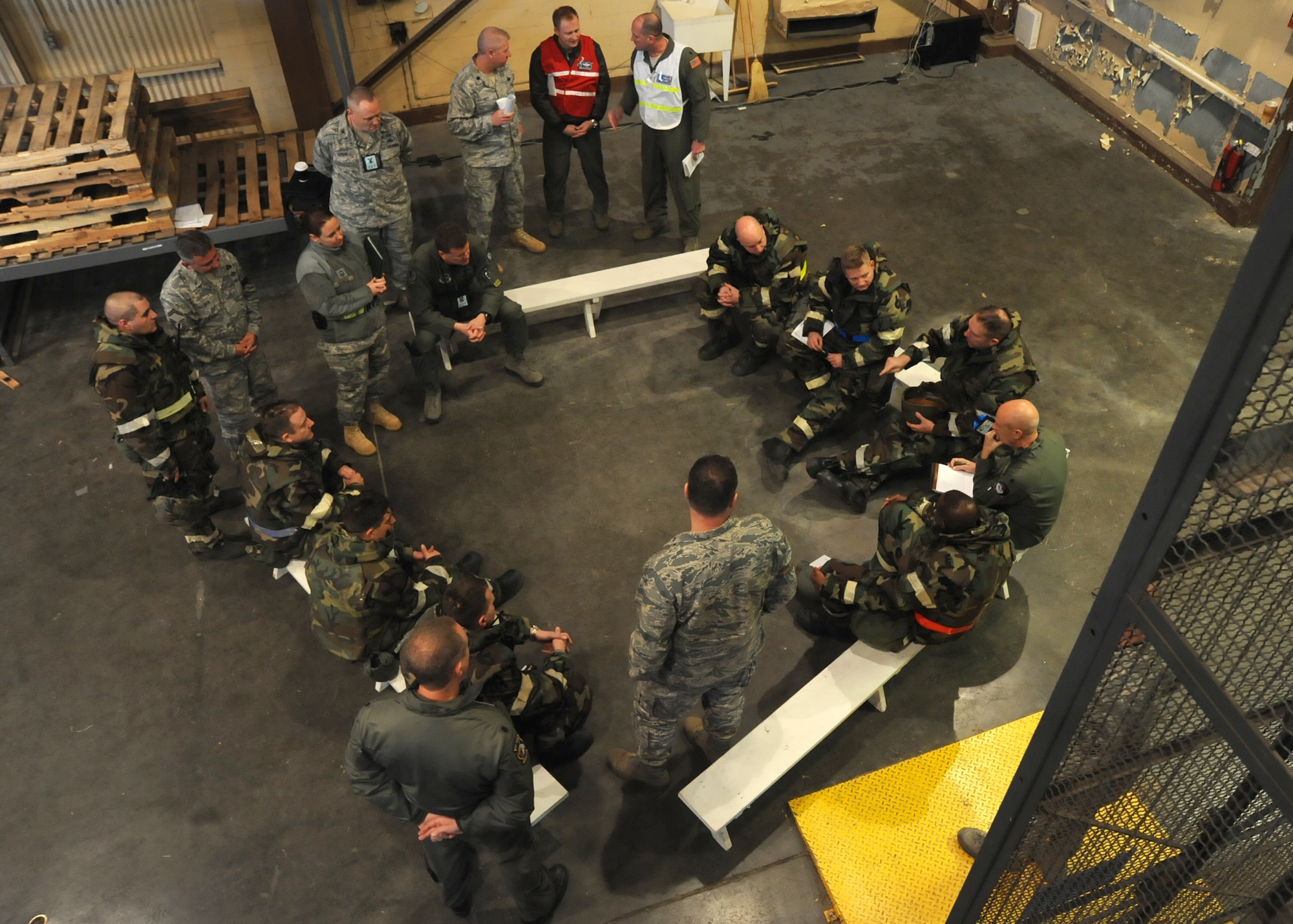 Wing leaders and exercise evaluation team members meet to discuss Team McConnell’s performance after a simulated chemical attack during an operational readiness exercise, Feb. 11, 2011, McConnell Air Force Base, Kan. The ORE simulates deploying to an overseas location, where Airmen operate day-to-day activities while building a base from the ground up and experiencing hostile forces. (U.S. Air Force photo/Staff Sgt. Dallas Edwards)