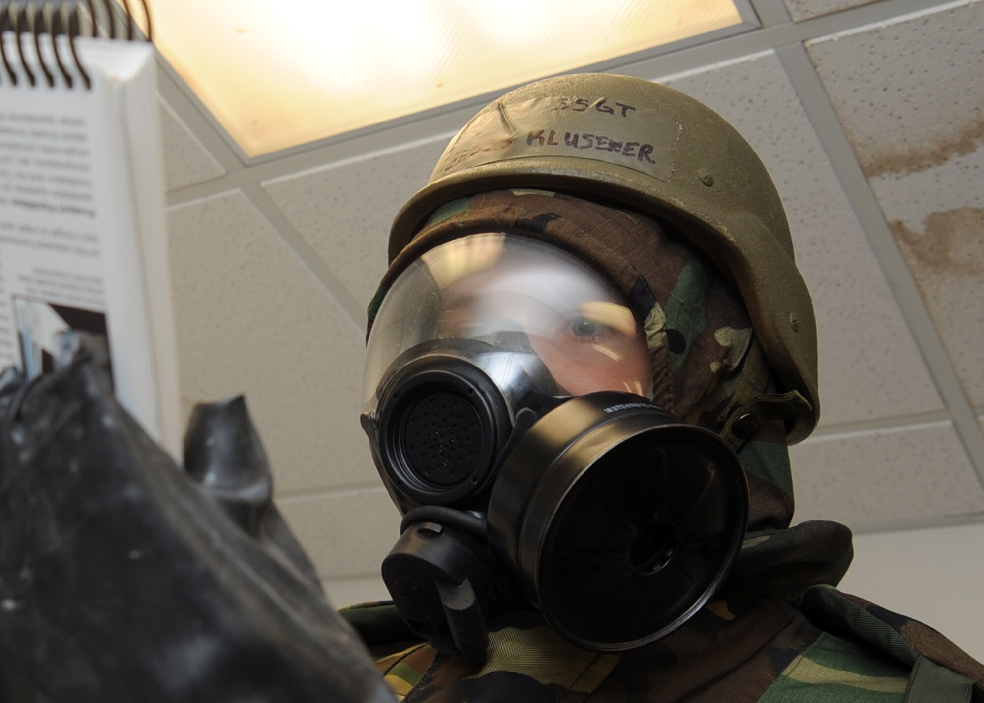 Staff Sgt. James Klusener, 22nd Operations Support Squadron weather technician, reads his Airman’s Manual during a base operational readiness exercise “chemical attack,” Feb. 15, 2011, McConnell Air Force Base, Kan. The ORE allows Airmen to practice surviving and operating in a simulated hostile environment.(U.S. Air Force photo/Staff Sgt. Dallas Edwards)