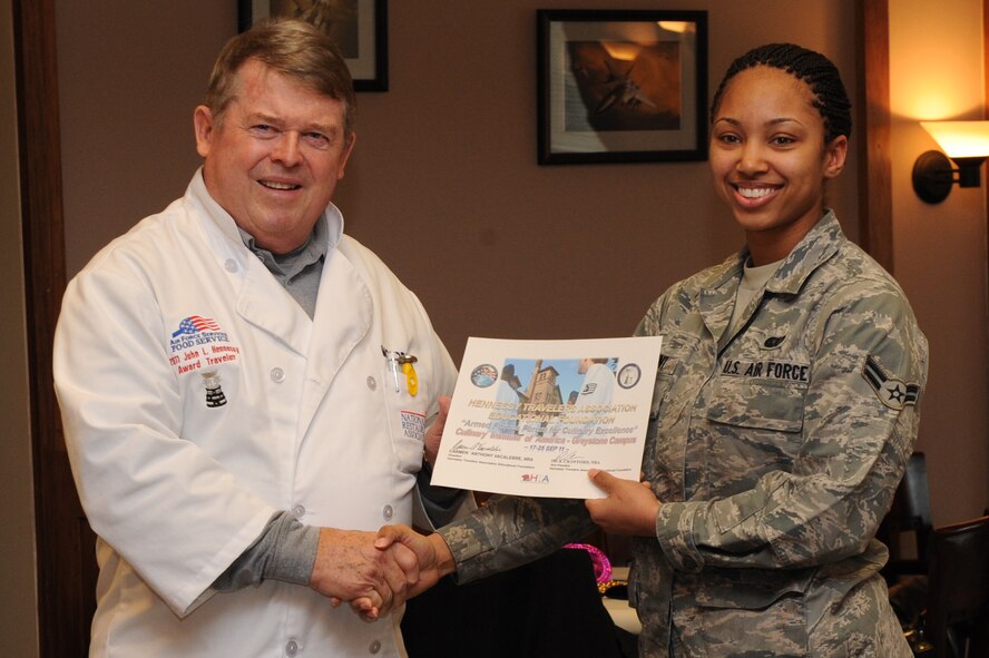 SEYMOUR JOHNSON AIR FORCE BASE, N.C. – William McCormick presents Airman 1st Class Precious Avent with an Air Combat Command Hennessy Traveler certificate Feb. 11, 2011. As part of this special recognition, Airman Avent will receive an all-expense paid trip to the Culinary Institute of America at the Greystone Campus in St. Helena, Calif. While there she will receive specialized, hands-on training from culinary field experts. Mr. McCormick is a member of the National Restaurant Association. Airman Avent, who hails from Henderson, is a 4th Force Support Squadron Southern Eagles Dining Facility food services apprentice. (U.S. Air Force photo/Robin DeMark)  
