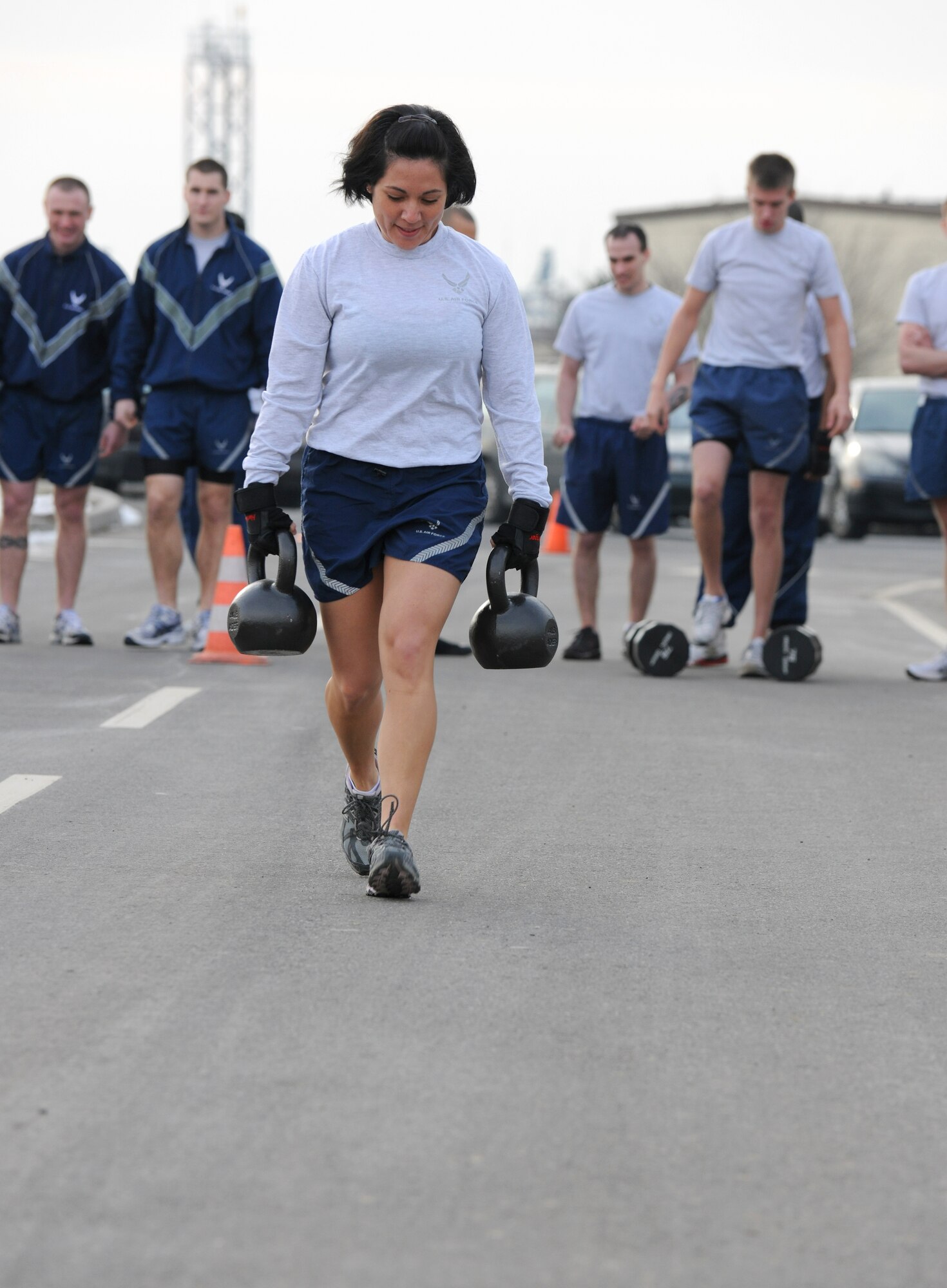 SPANGDAHLEM AIR BASE, Germany – Capt. Erin Pinkston, 52nd Force Support Squadron, runs with kettlebells during the Spangdahlem Air Base Iron Flight Competition at the Combat Fitness Center here Feb. 23. The competition consisted of six-person teams from squadrons across the base and consisted of a variety of individual and team challenges. The 52nd Communications Squadron won the competition out of the four teams that competed. (U.S. Air Force photo/Senior Airman Nathanael Callon)