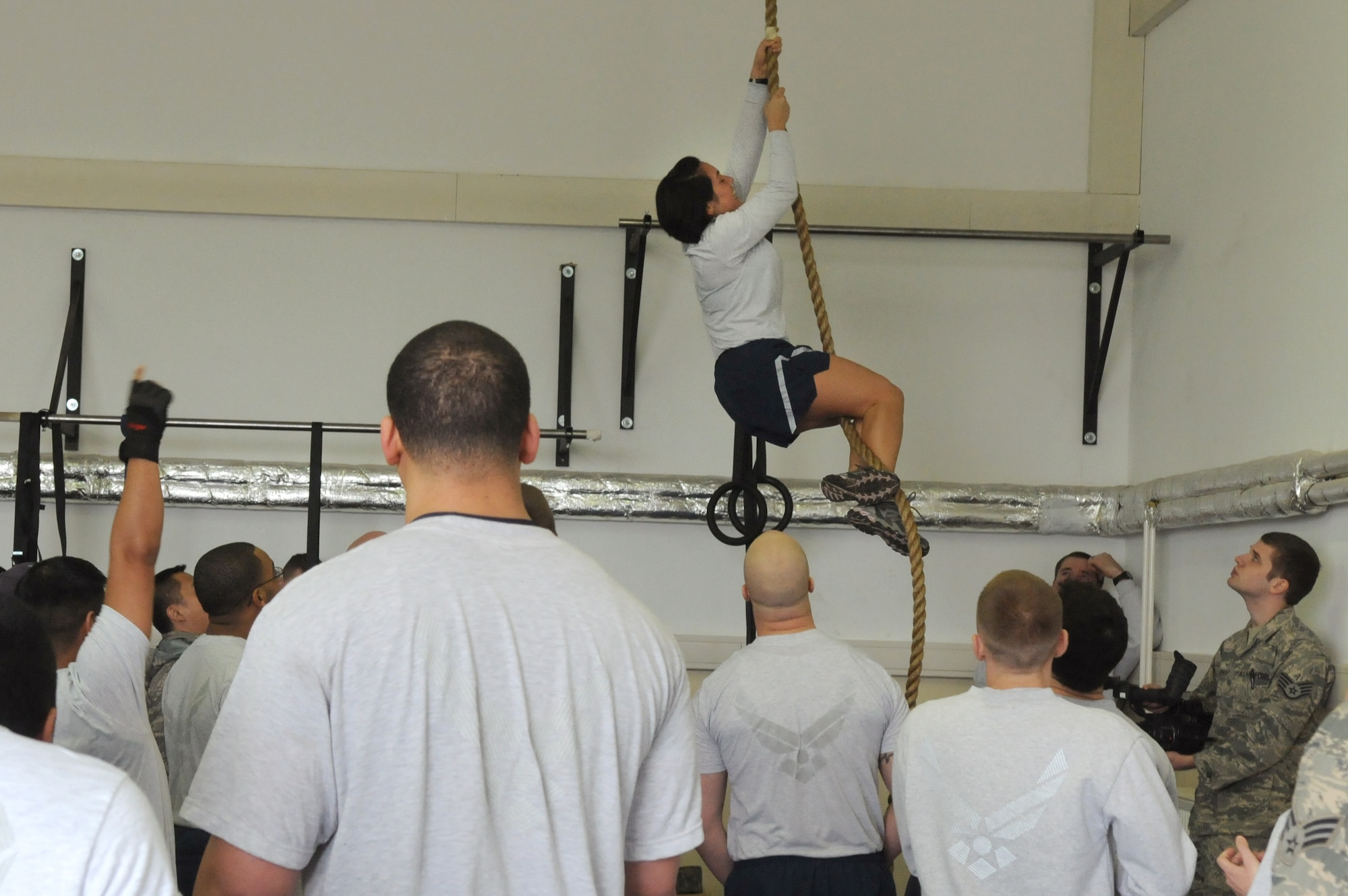 SPANGDAHLEM AIR BASE, Germany – Capt. Erin Pinkston, 52nd Force Support Squadron, climbs a rope during the Spangdahlem Air Base Iron Flight Competition at the Combat Fitness Center here Feb. 23. The competition consisted of six-person teams from squadrons across the base and consisted of a variety of individual and team challenges. The 52nd Communications Squadron won the competition out of the four teams that competed. (U.S. Air Force photo/Senior Airman Nathanael Callon)