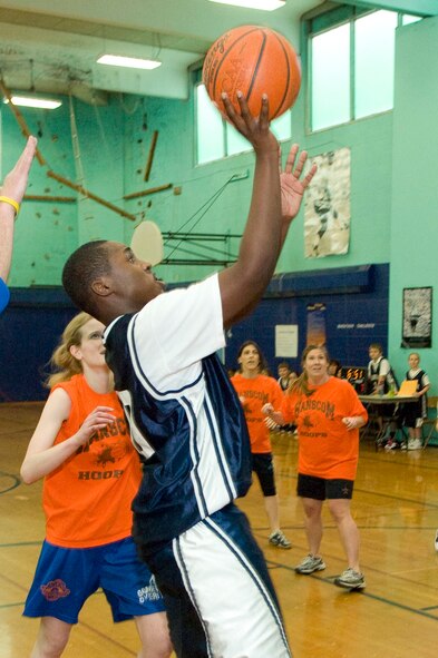 HANSCOM AIR FORCE BASE, Mass. - Eighth Grade student Brandon Jackson goes up for a lay-up during a game at Hanscom Middle School on Feb. 18. The teachers and staff took on the Hanscom boys and girls middle school basketball teams during this special athletic event. (U.S. Air Force photo by Mark Wyatt)