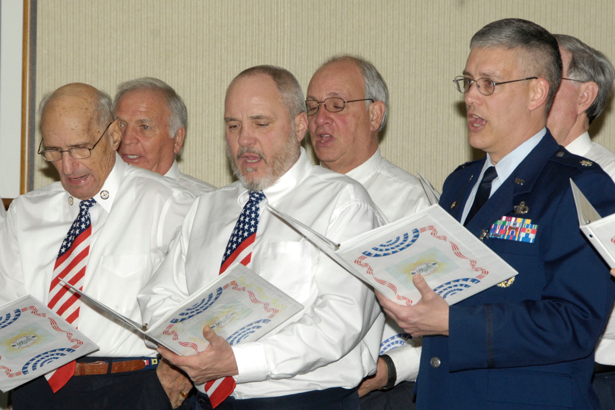 HANSCOM AIR FORCE BASE, Mass. - Lt. Col. Bruce Lambert (right), Air Force Research Laboratory program manager for space weather research, performs with the Leominster, Mass.-based International Veterans Chorus during his retirement ceremony Feb. 18. (U.S. Air Force photo by Linda LaBonte-Britt)