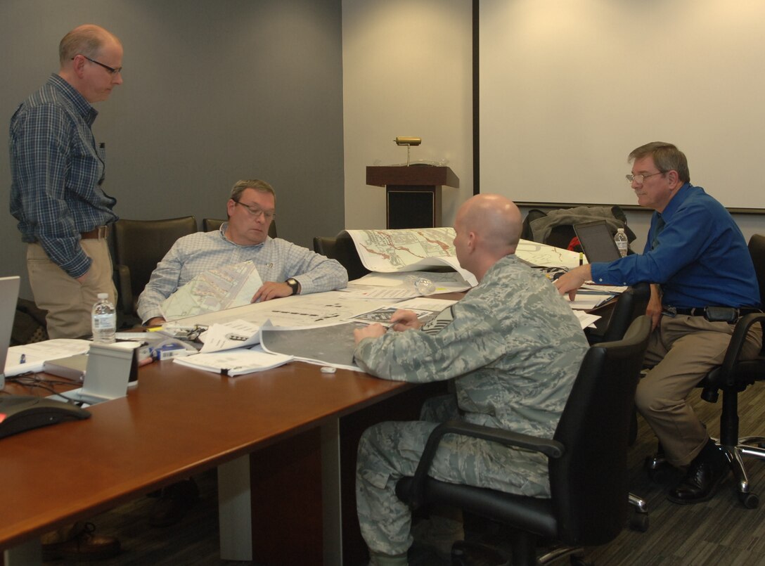 (From left to right) Tommy Downing, 7th Civil Engineer Squadron community planner from Dyess Air Force Base, Texas; Ted Shierk, Air Force Center for Engineering and the Environment and landscape architect from Lackland AFB, Texas; Master Sgt. Matthew Lee, 28th Maintenance Group squadron facilities manager; and Stan Gross, AFCEE community planner and team lead from Lackland AFB, Texas; evaluate plans for airfield improvements at Ellsworth Air Force Base, S.D, Feb. 16.  AFCEE responds to the needs of the Air Force by offering assistance in making long-range plans regarding military assets and facilities.  (U.S. Air Force photo/Airman 1st Class Alessandra N. Gamboa)