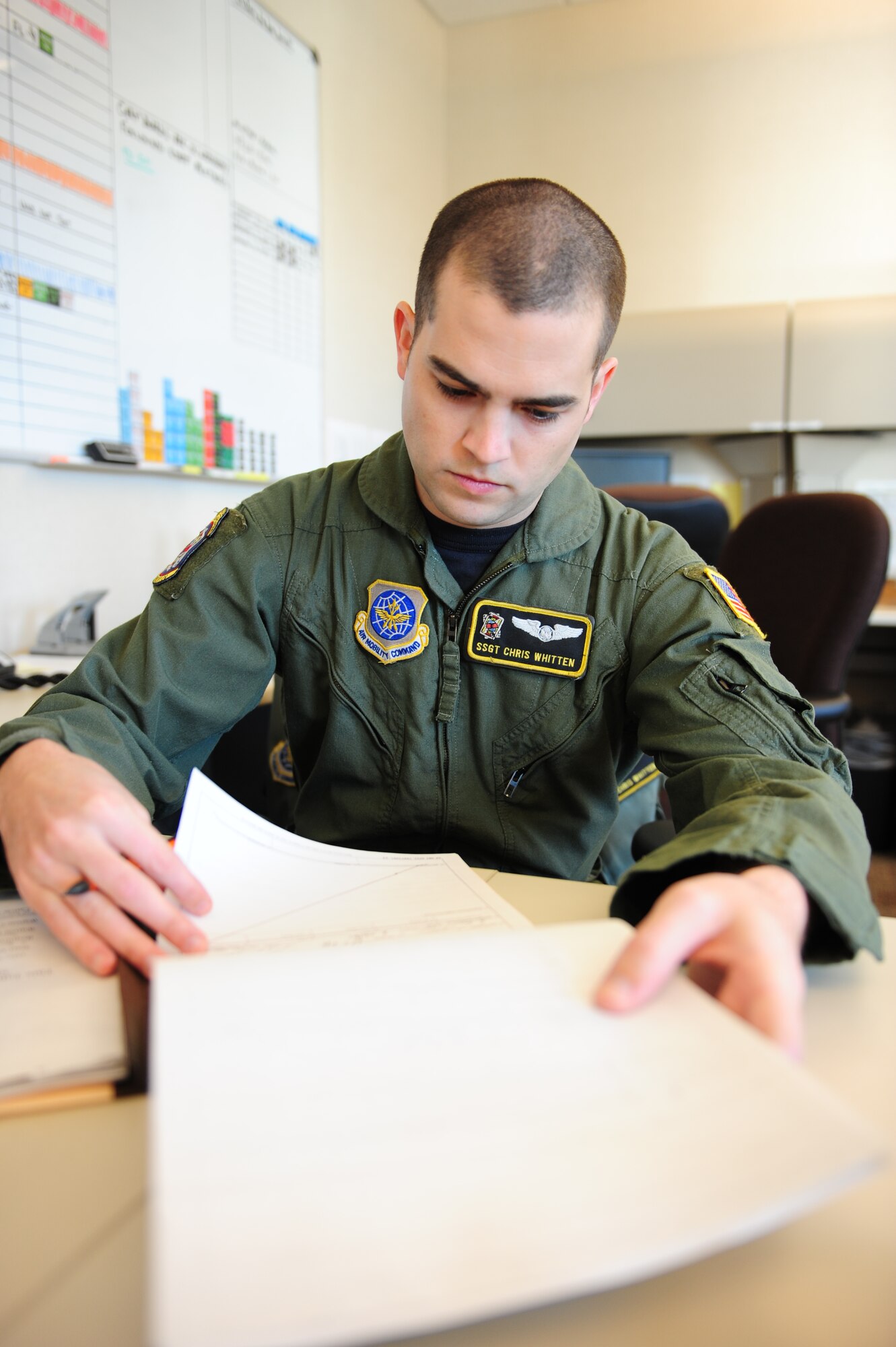 Staff Sgt. Christopher Whitten, a 53rd Airlift Squadron instructor flight engineer, reviews training records Feb. 22, 2011, at Little Rock Air Force Base, Ark. As the unit training manager, the Millington, Tenn., native tracked 18 career development courses and cut self inspection time in half by implementing a new process. (Air Force photo by Senior Airman Jim Araos)