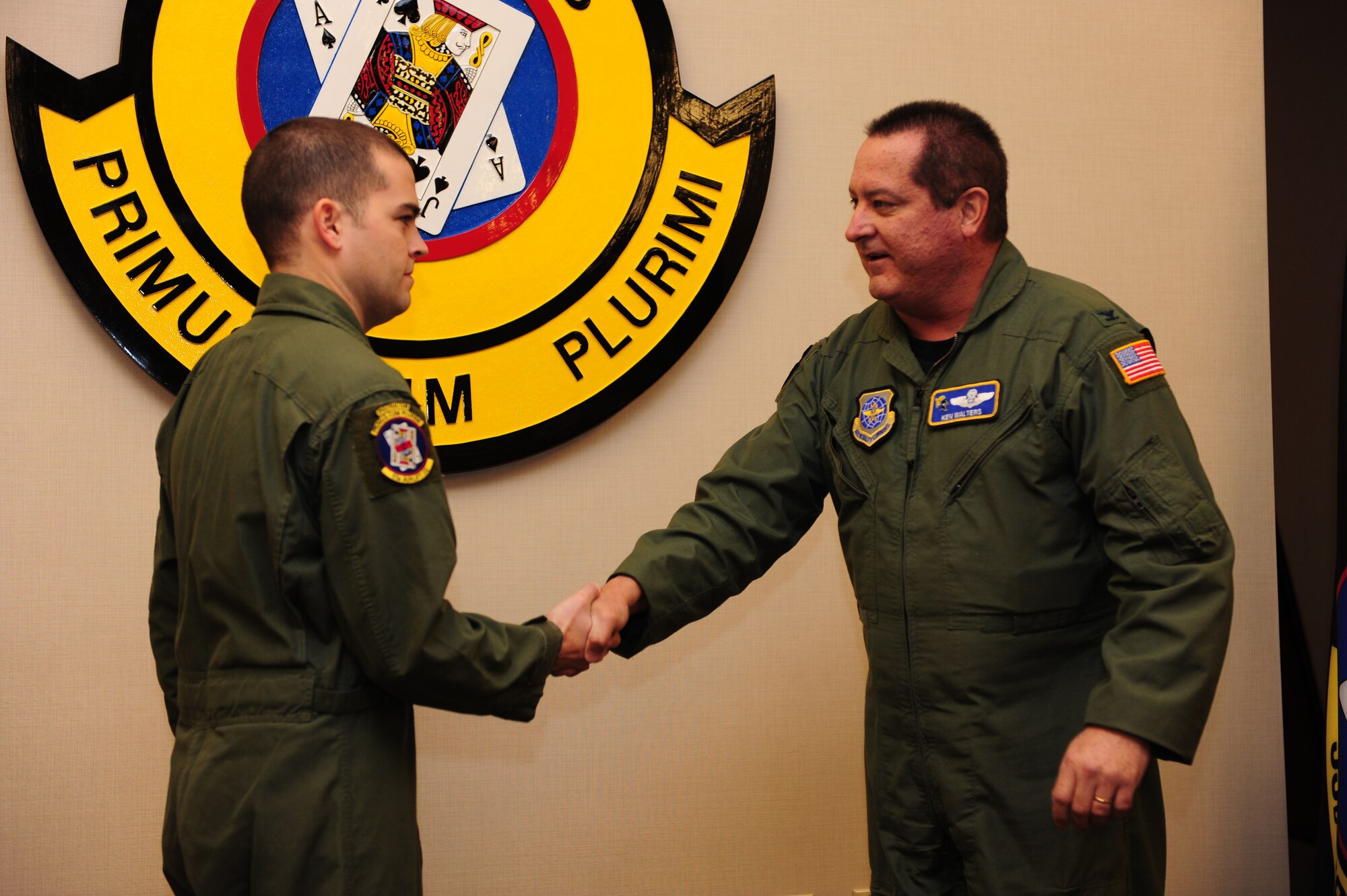 Col. Ken Walters (right), acting 19th Airlift Wing vice commander, presents a coin Feb. 22, 2011, to Staff Sgt. Christopher Whitten, a 53rd Airlift Squadron instructor flight engineer, for his selection as the Combat Airlifter of the Week at Little Rock Air Force Base, Ark. Sergeant Whitten is the lead instructor for the squadron’s C-130H1 conversion and provided ground instruction for 24 redeploying flyers to ensure mission readiness. (Air Force photo by Senior Airman Jim Araos)