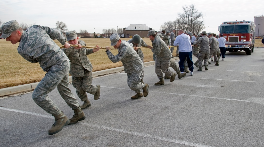 A team of 11th Civil Engineer Squadron members pull an 18-ton squadron fire truck over an 80-feet incline during the team building exercise portion of Wingman Day Feb. 22. (U.S. Air Force photo/Bobby Jones)