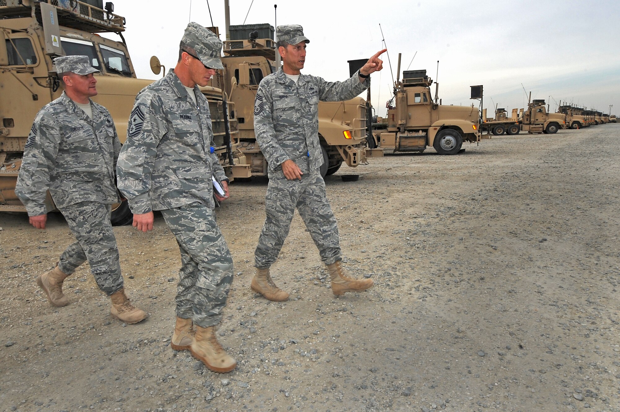 U.S. Air Forces Central Command Chief Master Sgt. Richard Parsons walks through the 387th Expeditionary Logistics Readiness Squadron parking lot with 386th Air Expeditionary Wing Command Chief Master Sgt. Richard Turcotte and Chief  Master Sgt. Billy Davis while touring the 386th AEW units around the region Feb. 10. Chief Parsons visited with 386th AEW Airmen during his first official visit here since becoming the AFCENT Command Chief. (U.S. Air Force photo by Senior Airman Cynthia Spalding)