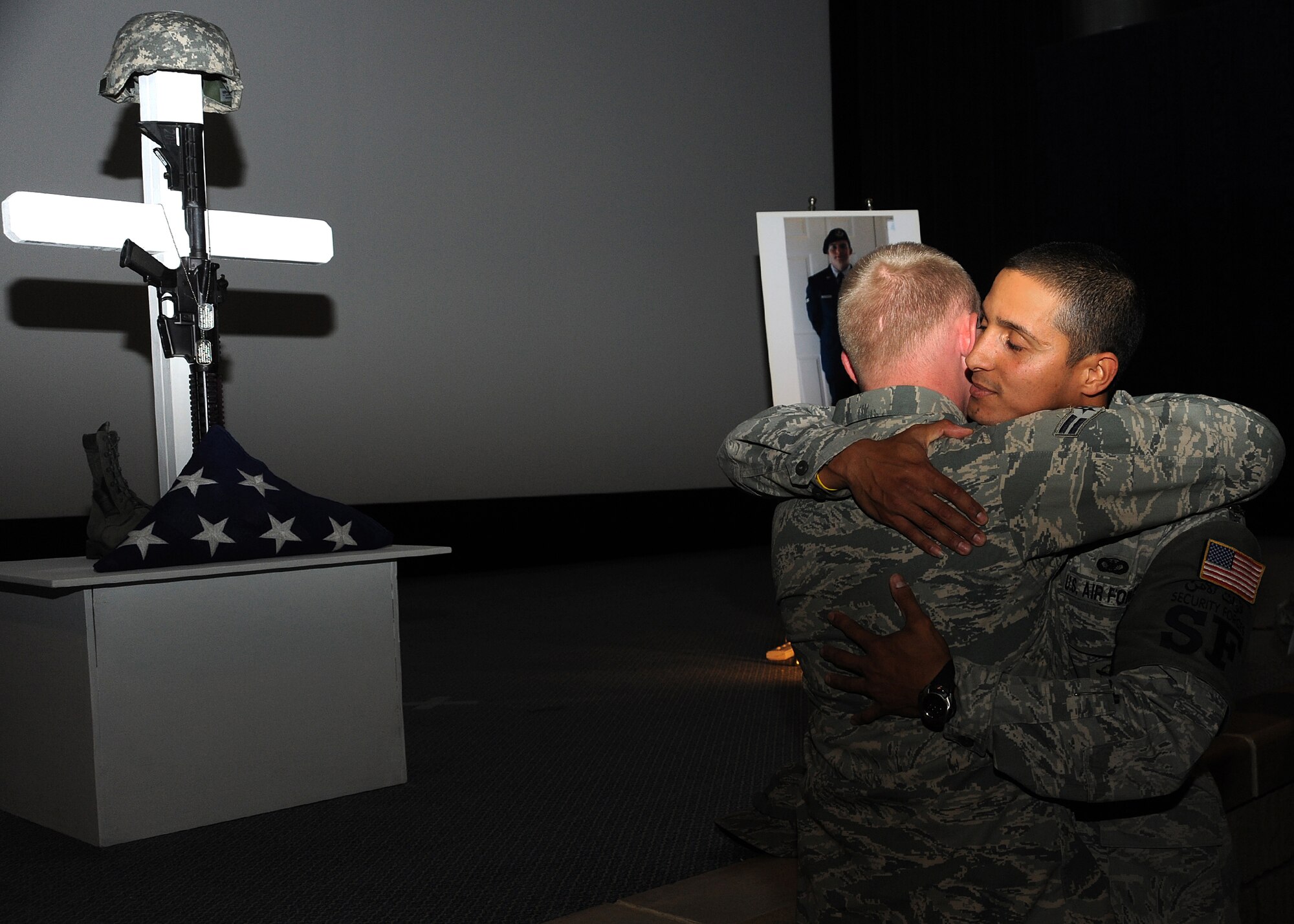 Security Forces Airmen mourn the loss of Airman 1st Class Christoffer P. Johnson, during a memorial ceremony, Feb. 21. Airman Johnson died Feb. 17 in a non-combat related incident. He was stationed with the 379th Expeditionary Security Forces Squadron in Southwest Asia.  (U.S. Air Force photo/Staff Sgt. Liliana Moreno)
