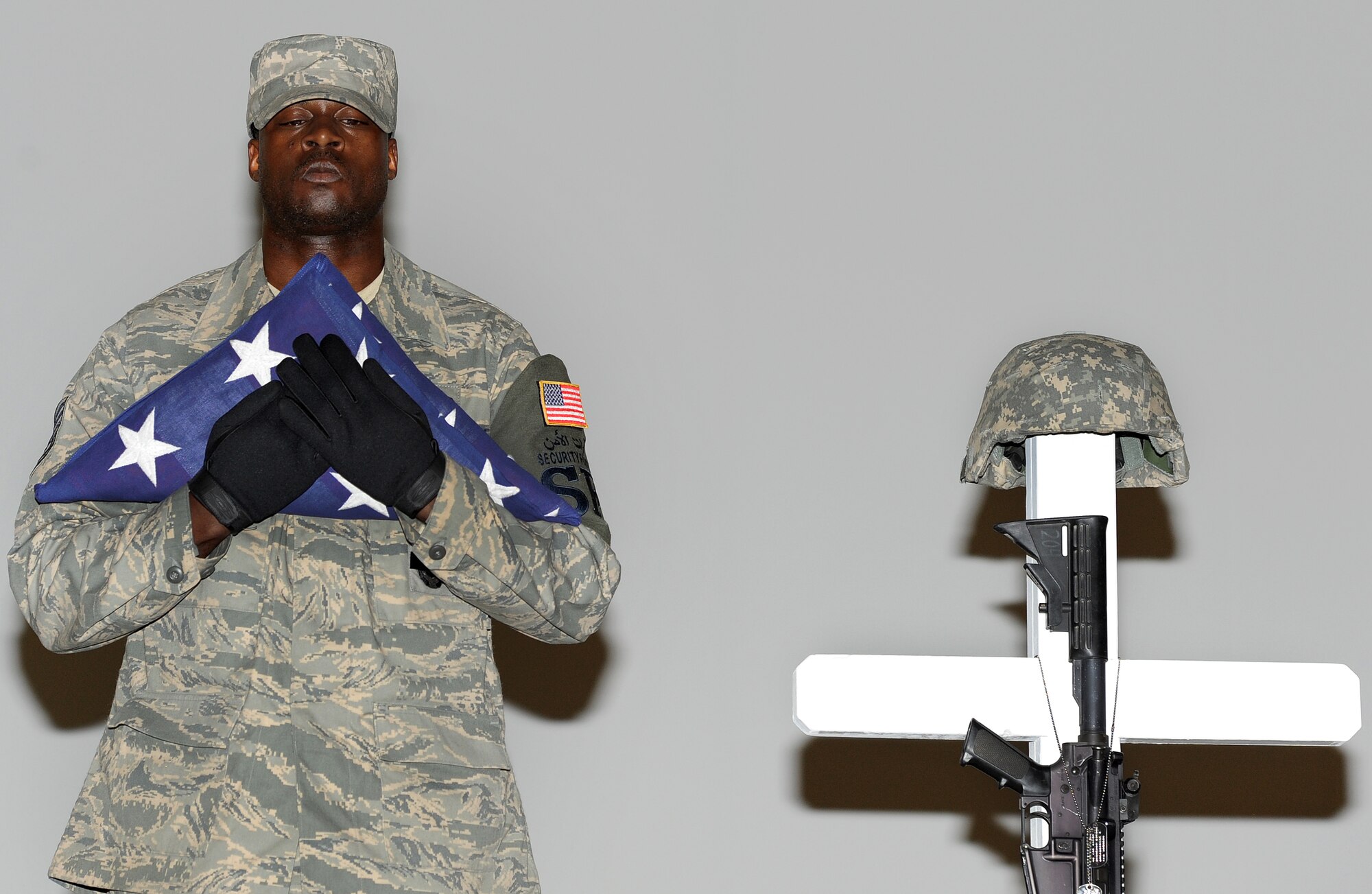 A Security Forces Airman pays tribute to Airman 1st Class Christoffer P. Johnson, during a memorial ceremony Feb. 21. Airman Johnson died Feb. 17 in a non-combat related incident. He was stationed with the 379th Expeditionary Security Forces Squadron in Southwest Asia.  (U.S. Air Force photo/Staff Sgt. Liliana Moreno)