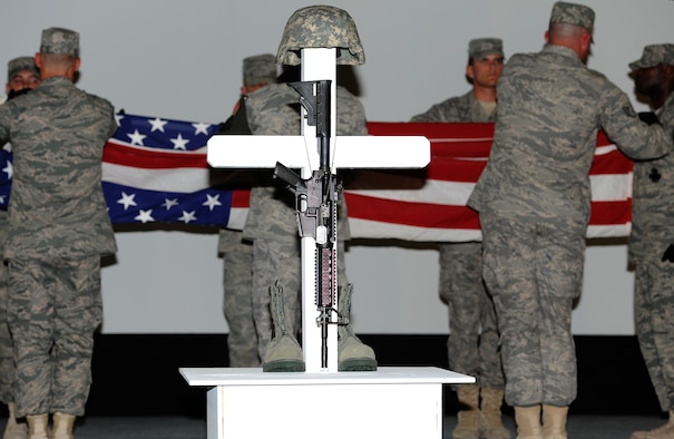 Security Forces Airmen perform a flag folding ceremony during a memorial ceremony, in honor of Airman 1st Class Christoffer P. Johnson, Feb. 21. Airman Johnson died Feb. 17 in a non-combat related incident. He was stationed with the 379th Expeditionary Security Forces Squadron in Southwest Asia.  (U.S. Air Force photo/Staff Sgt. Liliana Moreno)