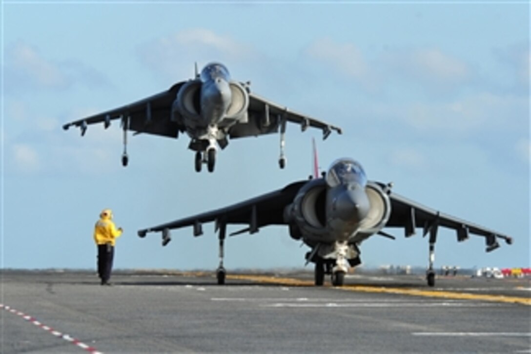 An AV-8B Harrier (right) assigned to Marine Attack Squadron 214 prepares for takeoff as another lands aboard the amphibious assault ship USS Makin Island (LHD 8) underway in the Pacific Ocean on Feb. 17, 2011.  The Makin Island is conducting AV-8 operations in preparation for an upcoming deployment.  