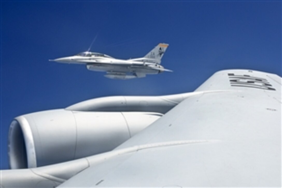 A U.S. Air Force F-16 D aircraft from the 132nd Fighter Wing based in Des Moines, Iowa, flies over Australia off the right wing of a KC-135 fuel tanker from the 185th Aerial Refueling Wing based in Sioux City, Iowa, Feb. 22, 2011. Both wing units are participating in a joint flight exercise, “Sentry Down Under,” with F-18s from the Royal Australian Air Force Base, Williamtown, Australia.