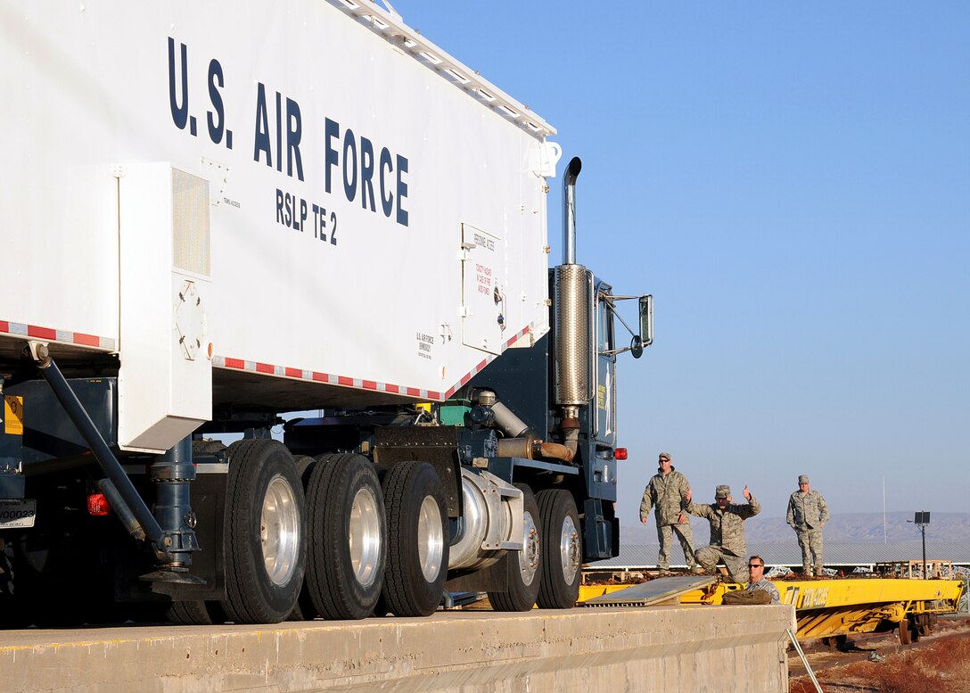 Airmen with the missile maintenance crew from 1st Air Space Test Squadron at Vanderberg AFB in Santa Barbara, Calif., load a transporter-erector-launcher onto the railhead at Marine Corps Logistics Base Barstow's Yermo Annex, Feb. 24. The TEL is a self-propelled vehicle which transports and erects a missile to the vertical position in order to launch it and the movement of the launcher is another example of the efficiency and productivity benefits gained by working in a joint military environment.