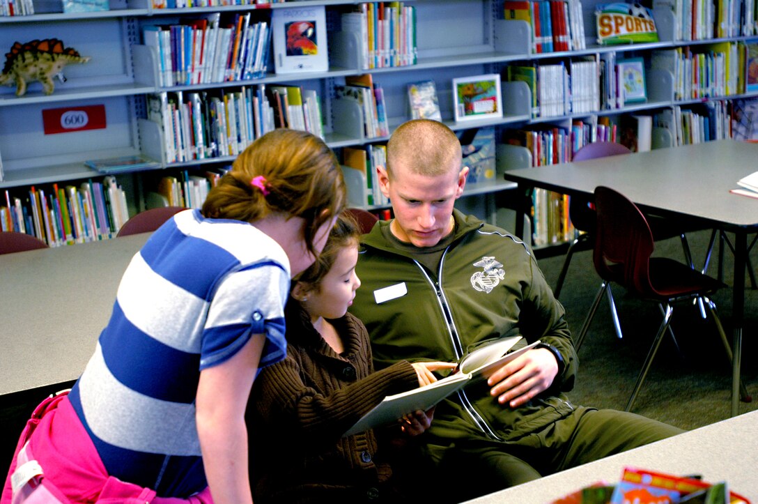Pfc. Jared McConnathy reads to second graders at Lindbergh Schweitzer Elementary’s library Feb. 24. The Basic Marine Platoon sends volunteers to Lindbergh Schweitzer every other week as a part of an ongoing service and learning partnership.
