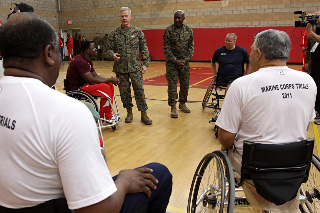 Gen. James F. Amos, 35th Commandant of the Marine Corps; and Sgt. Maj. Carlton W. Kent, Sgt. Maj. of the Marine Corps; both speak to injured Marines competing in the 2011 Marine Corps Trials at Camp Pendleton's Paige Field House, Feb. 25. Amos and Kent paid a visit in an effort to boost the morale of those competing. The trials are intended to select the top 50 Marine athletes to compete in the games as the All-Marine team for the Paralympics-style competition slated for May 2011. Marines competed along with allied forces and retirees in different sports including swimming, wheelchair basketball and sitting volleyball.