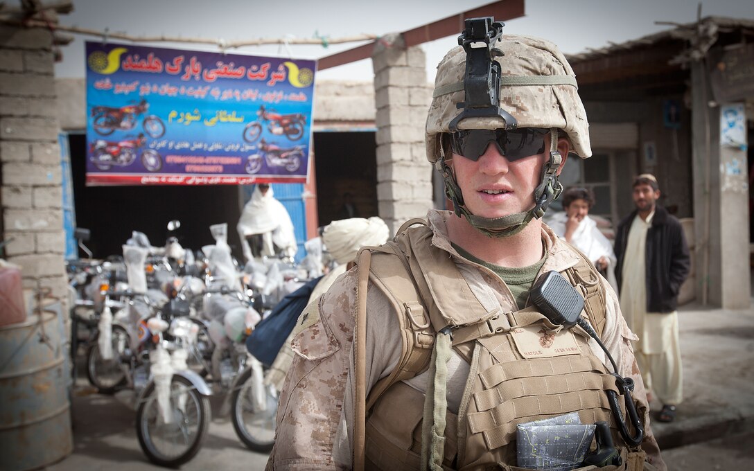 Lance Cpl. Bob Natole, a machine gunner with Golf Company, 2nd Battalion, 3rd Marine Regiment, stands outside a motorcycle dealership in Khalaj Bazaar, Garmsir District, Helmand province, Afghanistan, during a patrol on “Bazaar Friday,” Feb. 25. On Fridays, Khalaj Bazaar draws an average of about 3,000 villagers who gather to buy and sell livestock, meat, poultry, textiles, and various wares. The bazaar draws traders from as far as Herat province, in Western Afghanistan.