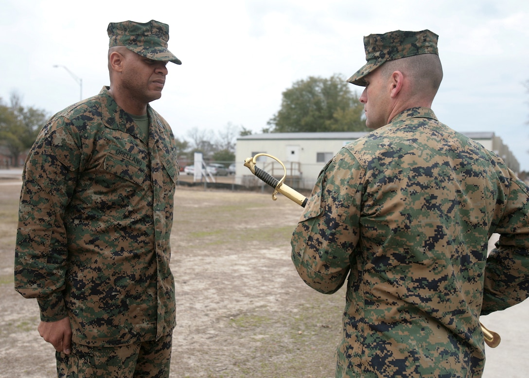 Lt. Col. Ralph J. Rizzo Jr., the commanding officer of Combat Logistics Battalion 6, 2nd Marine Logistics Group, passes a non-commissioned officer's sword to Sgt. Maj. Phillip A. Orellano during a post and relief ceremony aboard Camp Lejeune, N.C., Feb. 25. By accepting the 'sword of office,' Orellano takes his post as the battalion's senior enlisted advisor. (U.S. Marine Corps photo by Sgt. Justin J. Shemanski)
