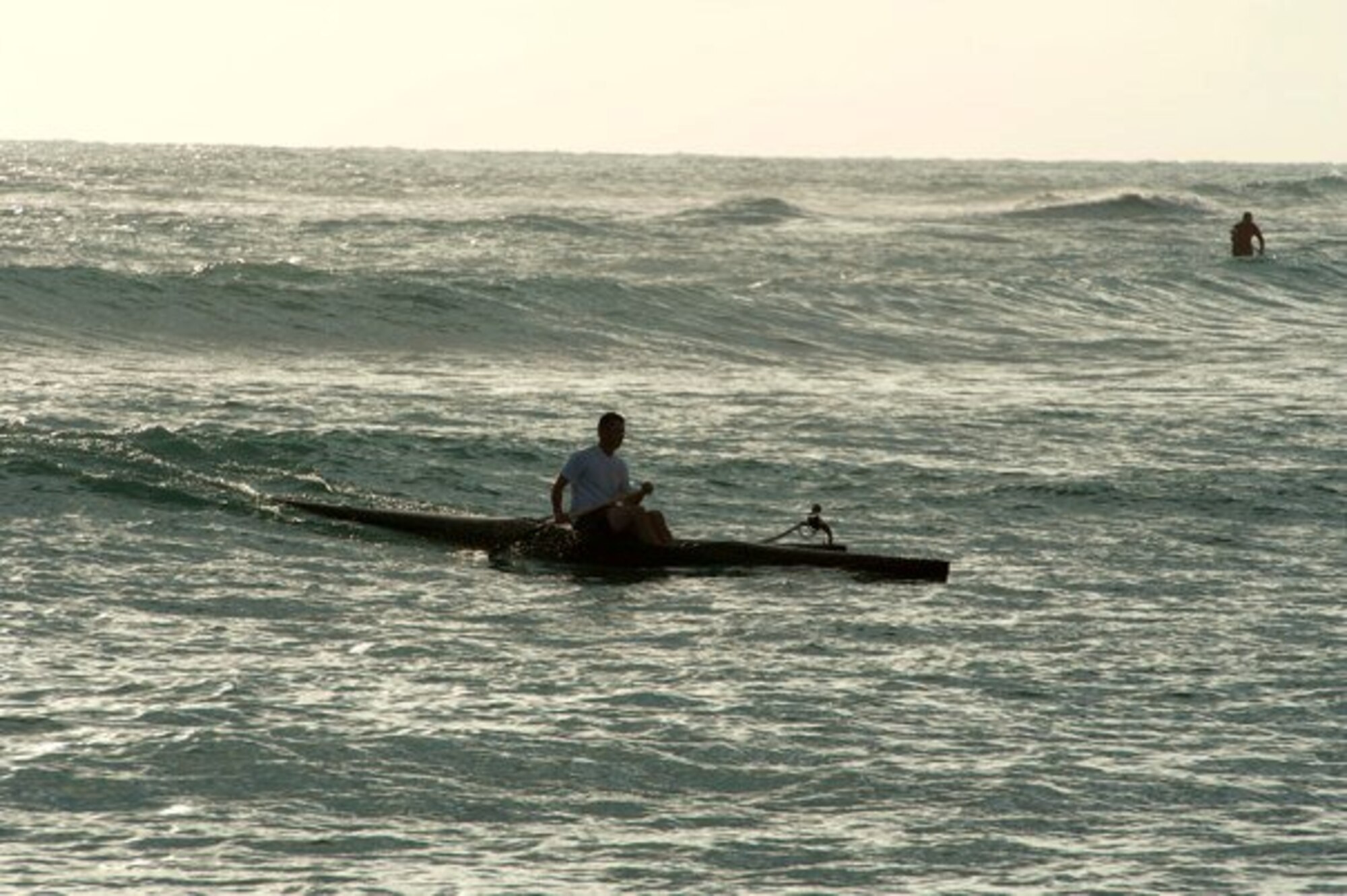 Master Sgt. Jeff Allen, a strategic plans technician with the Pacific  Air Forces public affairs office at Joint Base Pearl Harbor Hickam, paddles a canoe through the water off Hickam Beach Feb. 17. "Paddling" is a popular local pastime in which paddlers brave the Pacific Ocean in outrigger canoes ranging in size from one to six passengers. (U.S. Air Force photo by Staff Sgt. Nathan Allen)