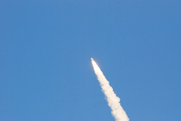 KENNEDY SPACE CENTER, Fla.  - Airmen from the 920th Rescue Wing out of nearby Patrick Air Force base, look on as Space Shuttle Discovery gets closer to orbit on her last mission. The Reserve Airmen provide NASA space shuttle support operations. Not only does aircraft maintenance keep Airmen on the go prior to and immediately after space shuttle launches, but as the rescue force charged as guardians of the astronauts, they must be prepared for taking off in their HH-60G Pave Hawk helicopters or HC-130P/N King aircraft to deliver recovery specialists, known as pararescuemen, to save the astronauts life wherever they end up. (U.S. Air Force photo/Capt. Matthew C. Simpson)