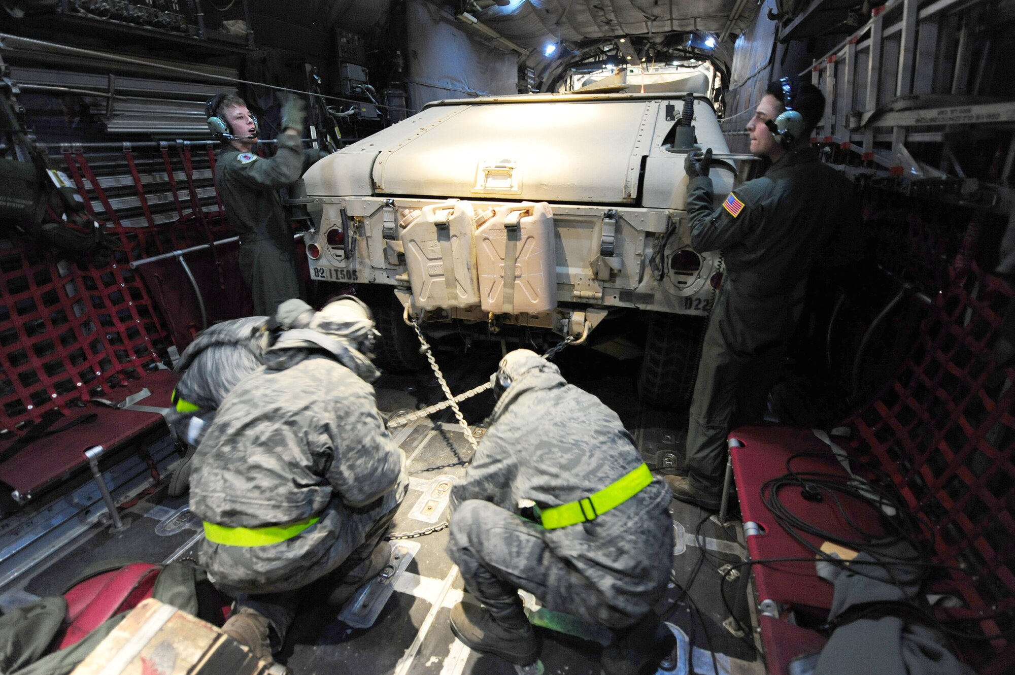 50th Airlift Squadron loadmasters strap down a Humvee on a C-130H Hercules during a Joint Operational Access Exercise Feb. 14, 2011, at Pope Air Force Base, N.C. The exercise trains Soldiers and Airmen to deploy at a moment's notice and sustain the mission anywhere in the world. (U.S. Air Force photo/Senior Airman Jim Araos)
