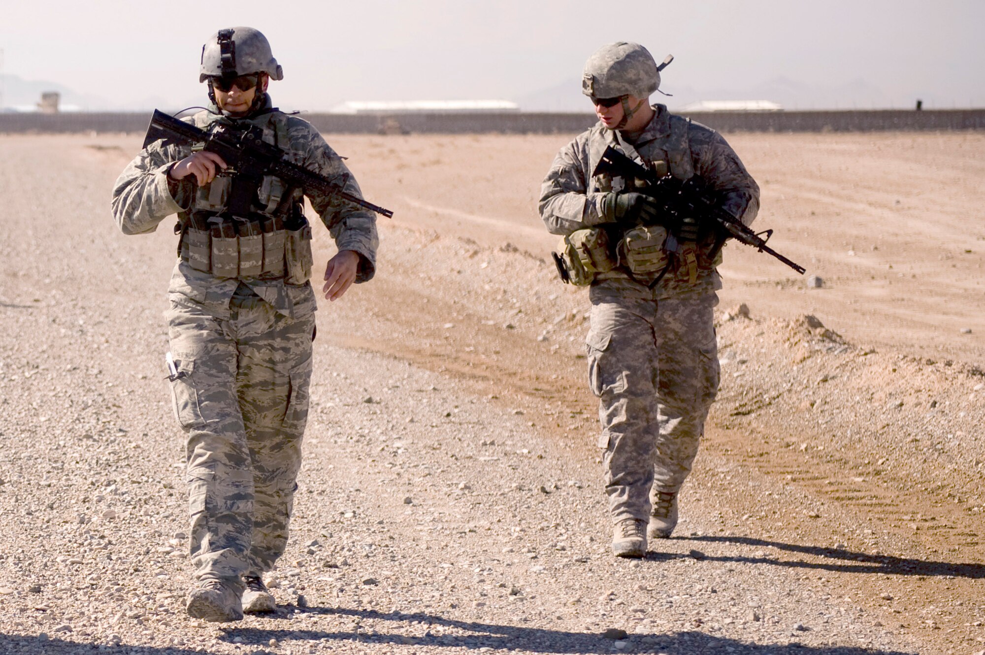 Senior Airman Jesse Medrano and Staff Sgt. Brandon Craig conduct a foreign object debris walk and inspection of a dirt landing zone in the Zabul Province of Afghanistan near FOB Lagman as part of the hands on portion of a Landing Zone Safety Officer class. The class consisted of U.S. Air Force, Army, and Romanian army members who were there to be certified to safely run the dirt landing and drop zone. The class was taught by U.S. Air Force instructors from Combined Joint Task Force 101, Headquarters Air Mobility Liaison Office. Airman Medrano is a joint terminal air controller with the 807th Expeditionary Air Support Operations Squadron at Forward Operating Base Lagman, Afghanistan. He is deployed from the 10th Air Support Operations Squadron at Ft. Riley, Kan.  Sergeant Craig is deployed from the 2nd Air Support Operations Squadron at Vilseck, Germany.  (U.S. Air Force photo/Master Sgt. Adrian Cadiz)