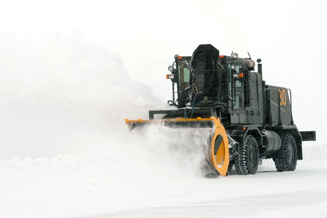 An Airman from the 28th Civil Engineer Squadron snow removal team clears snow from the runway at Ellsworth Air Force Base, S.D., Feb. 24, 2011. The team cleared the 4 inches of snow received overnight so the base could continue its mission. (U.S. Air Force photo/Senior Airman Kasey Close)