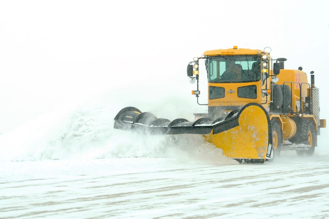 An Airman from the 28th Civil Engineer Squadron snow removal team clears snow from the runway at Ellsworth Air Force Base, S.D., Feb. 24, 2011. The 28th CES snow removal team helps keep the flightline and other paved areas clear for missions throughout the winter months. (U.S. Air Force photo/Senior Airman Kasey Close)