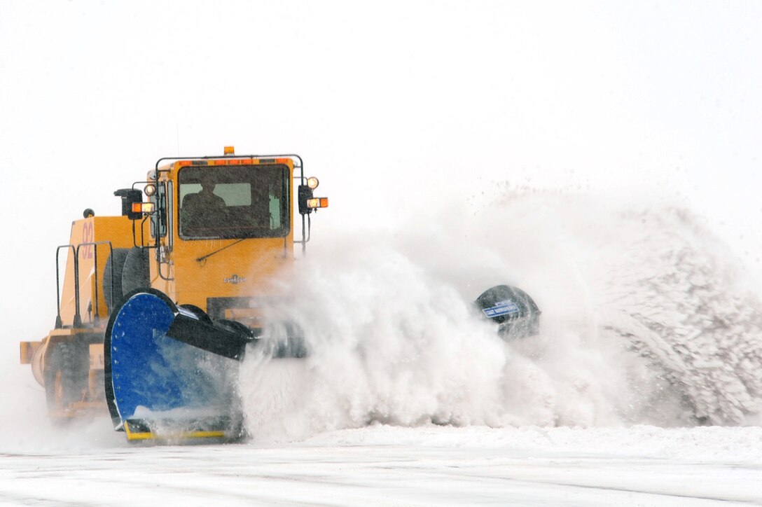 An Airman from the 28th Civil Engineer Squadron snow removal team clears snow from a taxiway at Ellsworth Air Force Base, S.D., Feb. 24, 2011. The snow removal team uses a variety of specialized equipment to sweep, blow and scrape snow from different paved areas. (U.S. Air Force photo/Senior Airman Kasey Close)