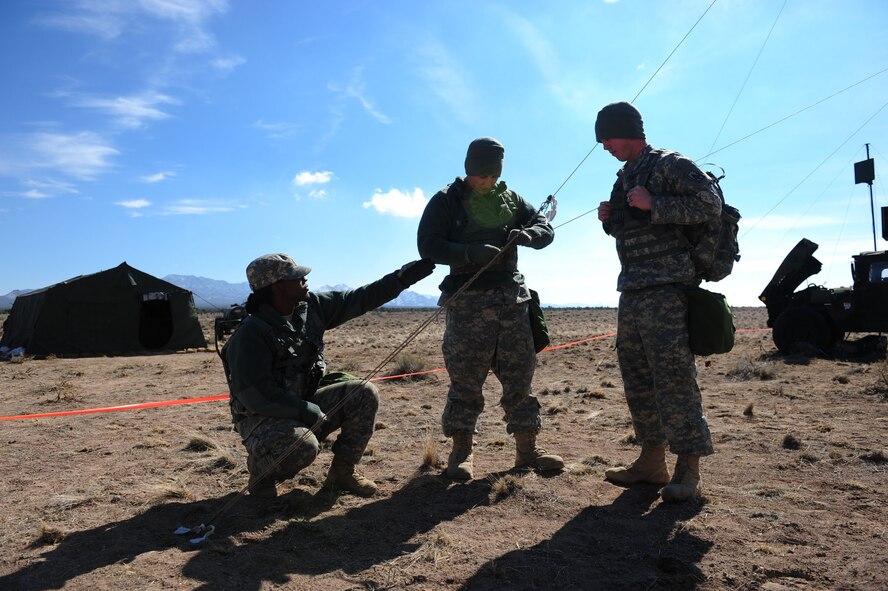 CALIENTE, Nev. -- Soldiers from Charlie Battery Patriot Crew 2, 1-7 Air Defense Artillery Battalion tighten guide wires for an ultra high-frequency radio antenna during Operation Red Flag 11-3 Feb. 24. The battalion's mission is to provide air defense for friendly forces and allies to allow freedom of maneuver. Red Flag is a realistic combat training exercise that provides heavily-contested and degraded operational environments to prepare crews for major combat operations against a near-peer adversary. (U.S. Air Force photo by 2nd Lt. Tony Richardson) (Released)
