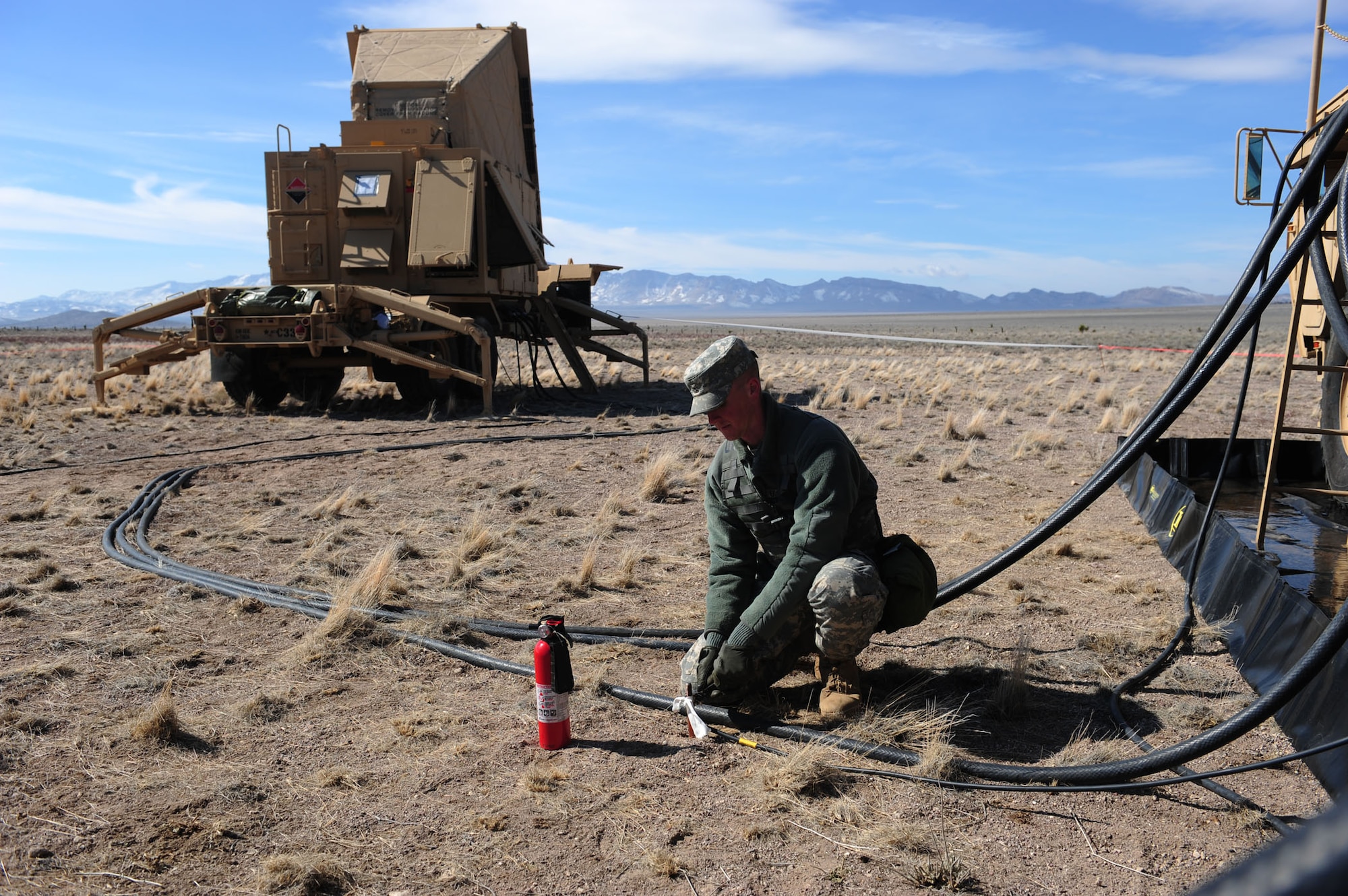 CALIENTE, Nev. -- Pvt. Aaron Giddings, 1-7 Air Defense Artillery Battalion Patriot fire control enhanced operator, tightens ground connections for an electric power plant during Operation Red Flag 11-3 Feb. 24. The battalion's mission is to provide air defense for friendly forces and allies to allow freedom of maneuver. Red Flag is a realistic combat training exercise that provides heavily-contested and degraded operational environments to prepare crews for major combat operations against a near-peer adversary. (U.S. Air Force photo by 2nd Lt. Tony Richardson) (Released)