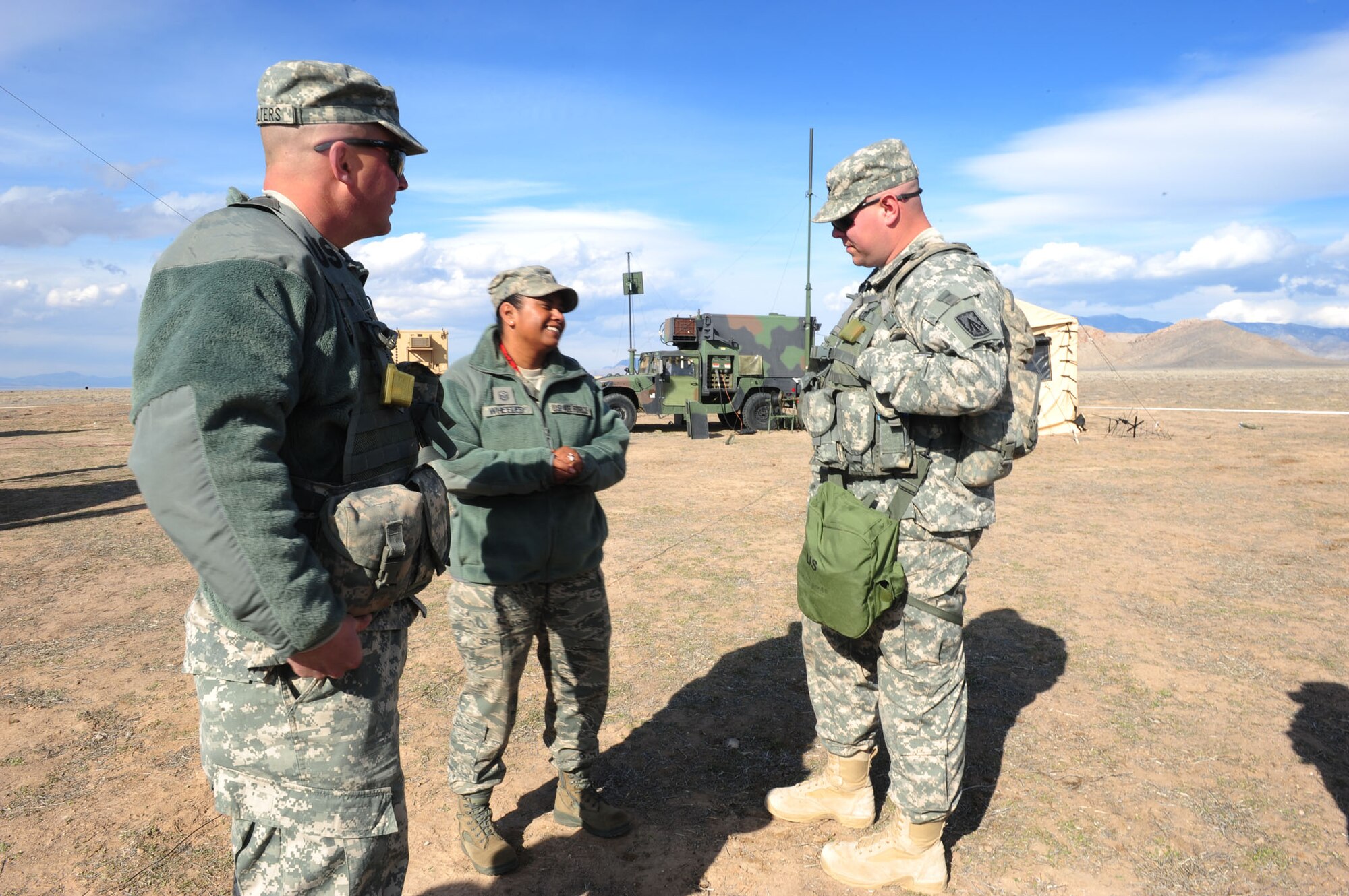 CALIENTE, Nev. -- U.S. Air Force Master Sgt. Melissa Wheeler, 20th Operational Support Squadron first sergeant, discusses joint cooperation with Army Soldiers from 1-7 Air Defense Artillery Battalion during Operation Red Flag 11-3 Feb. 24. The battalion's mission is to provide air defense for friendly forces and allies to allow freedom of maneuver. Red Flag is a realistic combat training exercise that provides heavily-contested and degraded operational environments to prepare crews for major combat operations against a near-peer adversary. (U.S. Air Force photo by 2nd Lt. Tony Richardson) (Released)