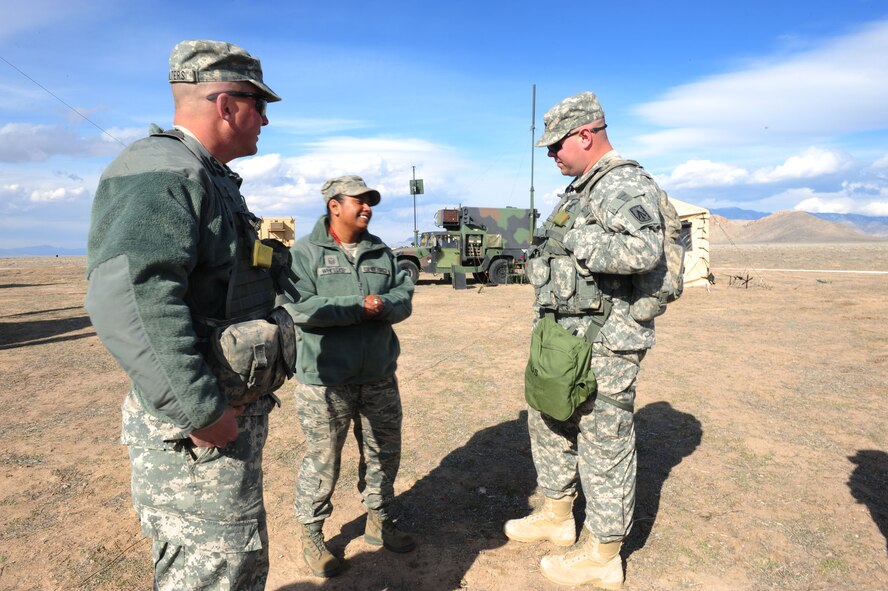 CALIENTE, Nev. -- U.S. Air Force Master Sgt. Melissa Wheeler, 20th Operational Support Squadron first sergeant, discusses joint cooperation with Army Soldiers from 1-7 Air Defense Artillery Battalion during Operation Red Flag 11-3 Feb. 24. The battalion's mission is to provide air defense for friendly forces and allies to allow freedom of maneuver. Red Flag is a realistic combat training exercise that provides heavily-contested and degraded operational environments to prepare crews for major combat operations against a near-peer adversary. (U.S. Air Force photo by 2nd Lt. Tony Richardson) (Released)