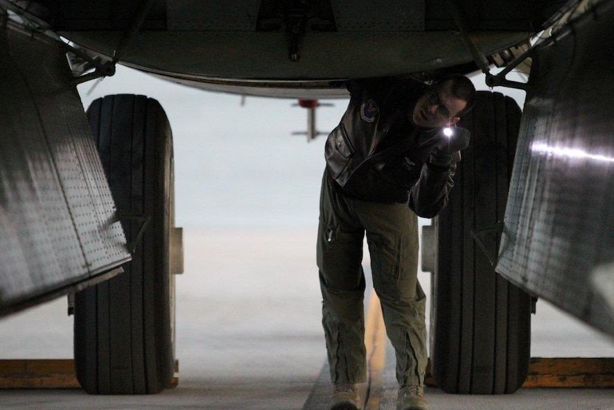 First Lt. Kevin Crawford, 96th Bomb Squadron, inspects a Barksdale B-52 bomb bay before one of many wartime training missions during Exercise Red Flag at Nellis Air Force Base, Nev. Exercise Red Flag is traditionally one of the Air Force’s most comprehensive training events preparing aviators for war. (courtesy photo) 