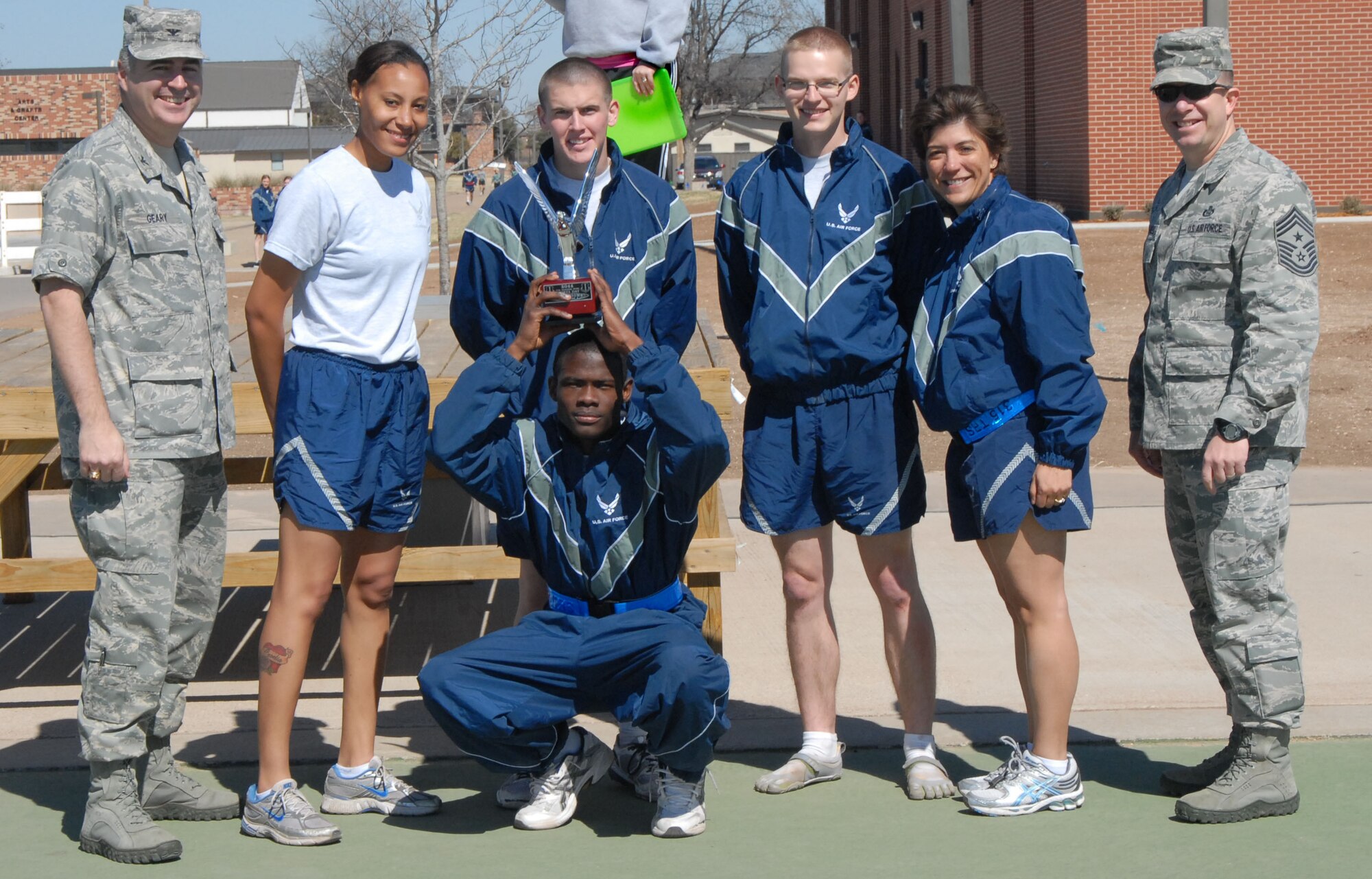 GOODFELLOW AIR FORCE BASE, Texas-- Col. Thomas Geary, 17th Training Wing Commander and  Chief Master Sgt. Brendan Criswell, 17th TRW Command Chief, present Lt. Col. Karen Rolirad, 315th Training Squadron Commander, and her team with the Quarterly Sports Day Large Unit Award, Feb. 25. (U.S. Air Force photo/Airman 1st Class Jessica Keith)